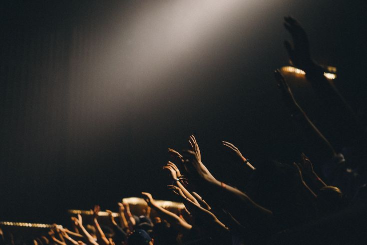 Hands raised up in worship in a church.